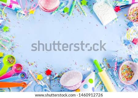 Sweet baking concept for birthday holiday party, cooking background with baking stuff - rolling pin, whipping whisk, cookie cutters, sugar sprinkling, flour. Light blue background, above copy space 
