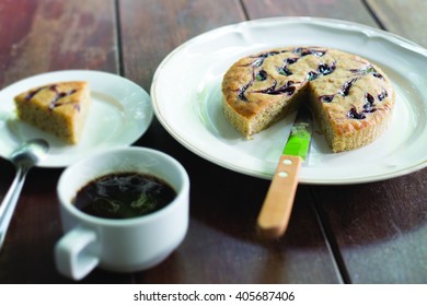  Sweet Banana Cake With Coffee In White Dish On Wooden Table
