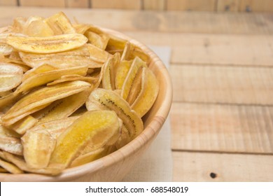  sweet banana crisps on wooden bowl