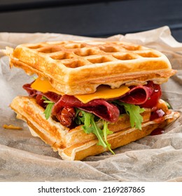 Sweet Belgian Waffles for Dessert or Breakfast, viennese waffles with ham parma and dried tomatoes