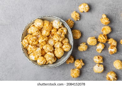 Sweet Caramel Popcorn In Bowl On Gray Table. Top View.