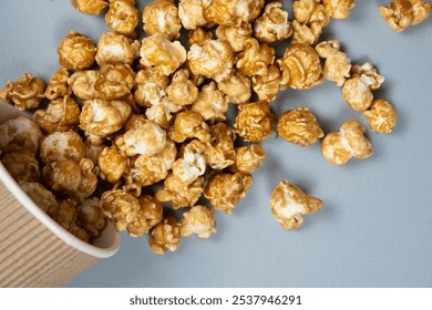 Sweet caramelized popcorn spilled out of the glass - Powered by Shutterstock