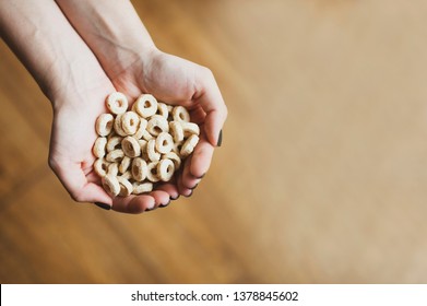Sweet cereal loops in hands. Corn flakes for breakfast. space for text - Shutterstock ID 1378845602