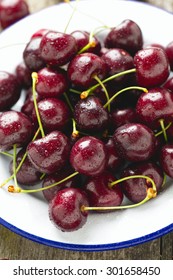 sweet cherry on a plate on wooden table