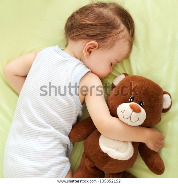 cute baby sleeping with teddy