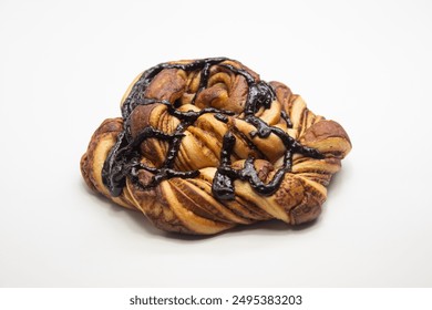 sweet chocolate bread in polygon shape with isolated chocolate topping on a white background 