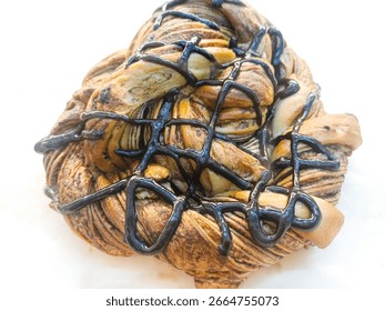 sweet chocolate bread in polygon shape with isolated chocolate topping on a white background