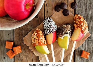 Sweet Chocolate And Caramel Dipped Apple Slices, Scene On A Rustic Wooden Background