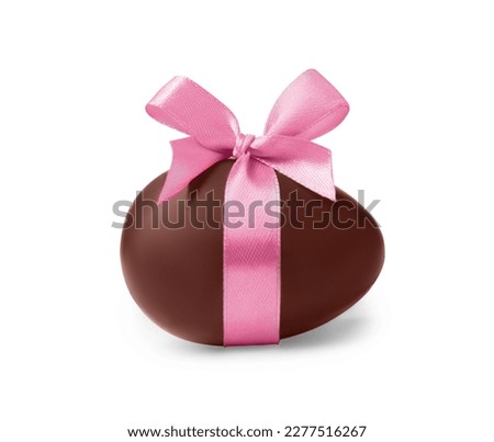 Sweet chocolate egg with pink bow isolated on white