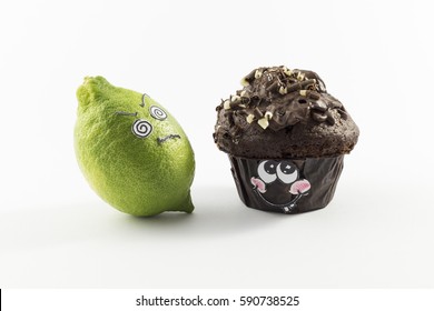 A sweet chocolate muffin and fresh lemon with cartoon style faces on white background opposing each other