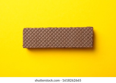 Sweet Chocolate Wafer Biscuit On Yellow Background, Top View