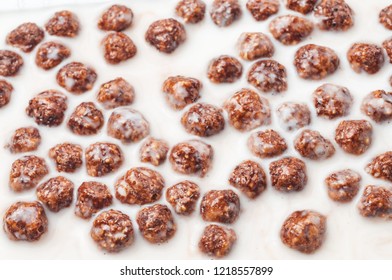 Sweet Cocoa Chocolate Sugar Cereal Puffs With Milk Closeup. Healthy Breakfast Concept.