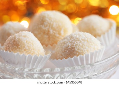 Sweet coconut balls - Christmas cookies on defocused background, selective focus.