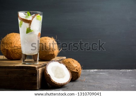 Sweet coconut mojito cocktail on the wooden background. Selective focus. Shallow depth of field.