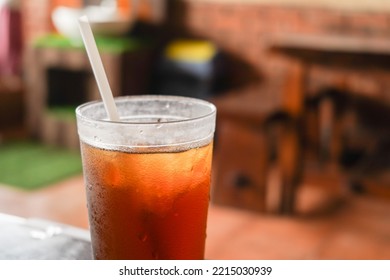 Sweet Cold Iced Tea In A Transparent Plastic Cup