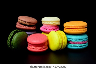 Sweet And Colorful French Macaroons Or Macaron On Black Background