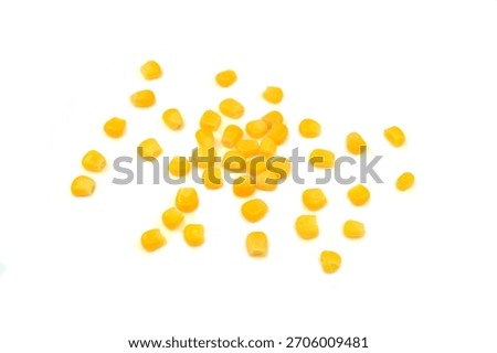 Sweet corn kernels isolated on white. Cooked canned yellow vegetable maize, Zea mays, also called sugar or pole corn, a vegetarian staple food. Isolated macro food photo close up from above. 
