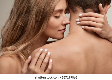 Sweet Couple In Love. Closeup Of Beautiful Sexy Young Woman With  Perfect Natural Makeup Embracing Man With Hands, Smelling Pure Smooth Soft Clean Neck Skin. Body Cosmetics Concept. High Resolution 