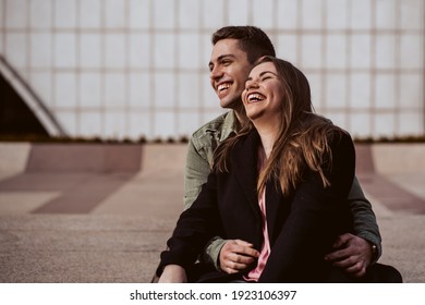 Sweet couple spending the day together outdoors. Cuddled, loving and having fun. Lifestyle