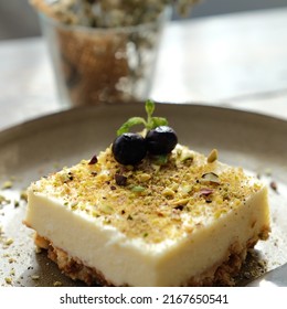 Sweet Creamy Dessert With Blueberry And Cookie Crumbs Garnish On A Ceramic Plate