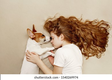 Sweet curly girl and jack russell dog is sleeping in night. - Powered by Shutterstock