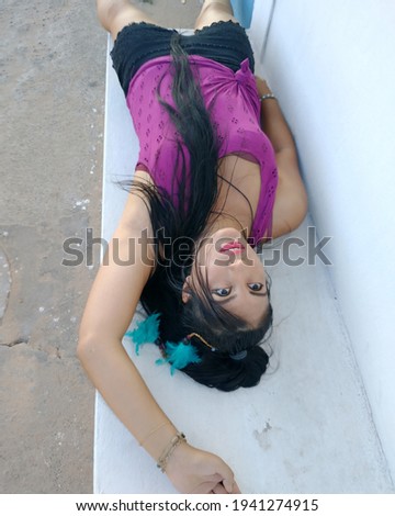 Similar – Woman at the window of a parking garage