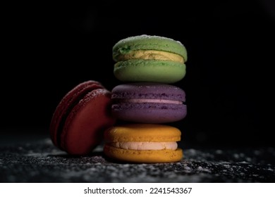 Sweet delicate macarons black background. Colorful macarons cakes. Small French cakes. Sweet and colorful french macaroons. - Powered by Shutterstock