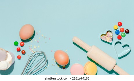 Sweet Dessert Concept, Various Confectionery Tools And Candy Macarons On Light Blue Background.