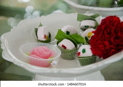 The sweet dessert in Thai style on the white dish with fresh red flower in the wedding event.