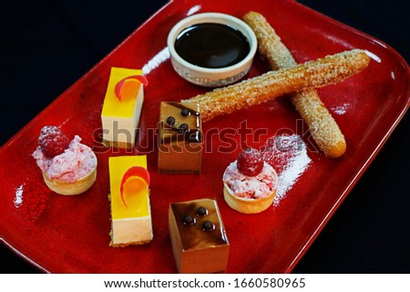 Sweet desserts and pastries on the table during the event. Catering servicing of guests and participants during mass events. Large number of sweet and cupcakes. Soft focus, bokeh, abstract