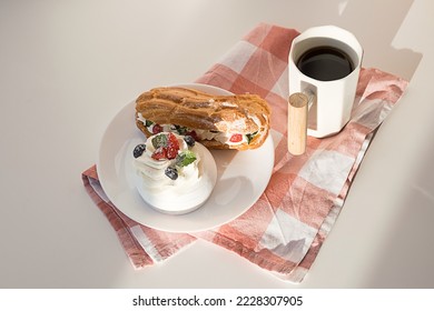 Sweet desserts with strawberry, blueberry and mint on white table. Continental breakfast with coffee mug .