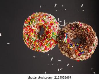 Sweet Donuts On A Gray Background In A Frozen Flight. Sweet Food, Children's Favorite Treat, Youth Culture. Birthday, Holiday. Shop, Cafe, Restaurant, Hotel. There Are No People In The Photo.