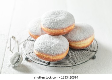 Sweet Donuts With Powdered Sugar On White Table