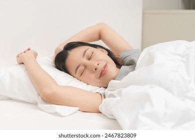 Sweet dreams, attractive smile pretty asian young woman, girl sleeping in comfortable bed lying on soft pillow resting, keeping eyes closed while with covered blanket in cozy white bed in the morning. - Powered by Shutterstock