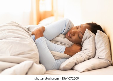 Sweet Dreams. Black Woman Sleeping Hugging Herself Lying In Bed At Home In The Morning. Selective Focus