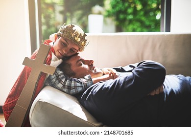 Sweet Dreams, Daddy. Shot Of A Little Boy In A Kings Costume Hugging His Sleeping Father On The Couch.