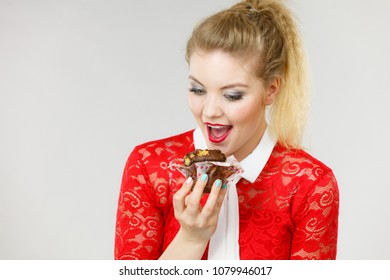 Sweet Food Sugar Make Us Happy. Attractive Blonde Woman Holds Yummy Chocolate Cupcake In Hand, Open Mouth, Craving For Cake.