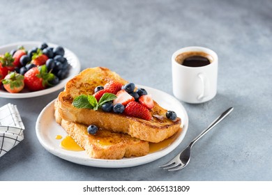 Sweet french challah toast with berries and syrup served on plate. Copy space for text or design elements