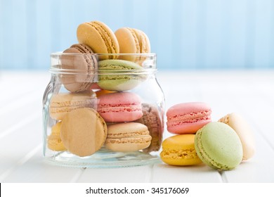 sweet french macarons in jar on kitchen table