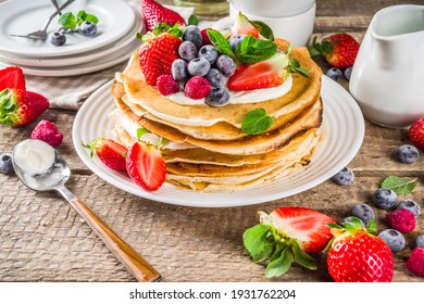 Sweet french and russian style homemade pancake crepes. Layered crepe cake with whipped cream or mascarpone cheese and fresh berries, 
