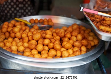 Sweet fried potato balls. Sweets in the Asian street food market. - Shutterstock ID 2242473301