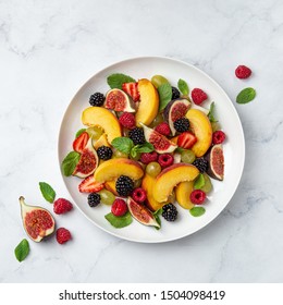 Sweet Fruit And Berry Salad On White Plate, Marble Baground, Top View, Square Image