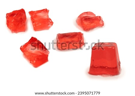Sweet fruit jelly dessert isolated on a white background. Gelatin cubes.