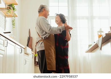 sweet good old day asian senior retired marry couple grand parent make lovely dance together while preparing breakfast at pantry kitchen daytime at home,morning dancing with love of grand parent home - Powered by Shutterstock