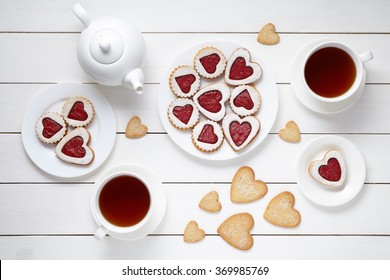 Sweet heart cookies for Valentines day with teapot and two cups of tea composition on white wooden background - Powered by Shutterstock