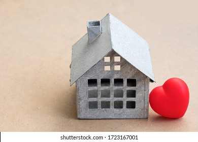 Sweet Home Concept, Mini Toy House And Red Heart On Wooden Background