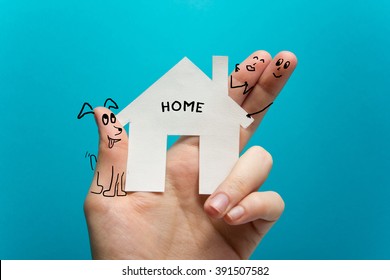 Sweet home. Hand holding white paper house figure on blue background. Real Estate Concept. Ecological building. Copy space top view. - Powered by Shutterstock