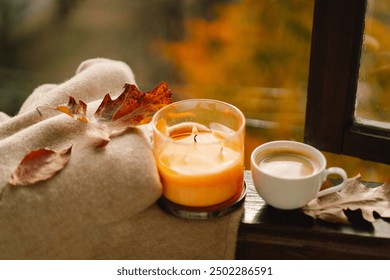 Sweet Home. Still life details in home on a wooden window. Sweater, candle, hot coffee and autumn decor. Autumn home decor. Cozy fall mood. Cozy autumn or winter concept. - Powered by Shutterstock