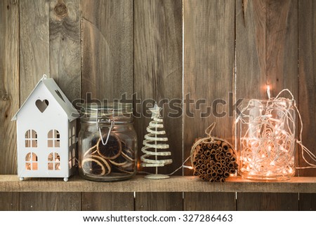 Sweet home. White Christmas decor on vintage natural wooden background. Cinnamon sticks and dried citrus. Cafe shelf.