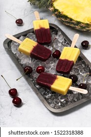 Sweet Homemade Popsicle With Fresh Pineapple And Cherries On Metal Tray Full Of Ice Cubes. Summer Dessert. Selective Focus.